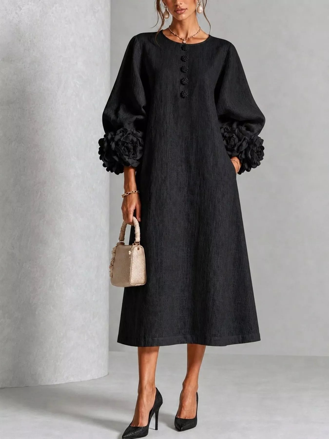 Black round neck midi dress with balloon sleeves, floral cuffs and small floral buttons, front view