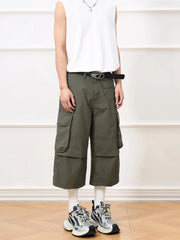 Men's army green cropped cargo pants with wide legs and a belt.