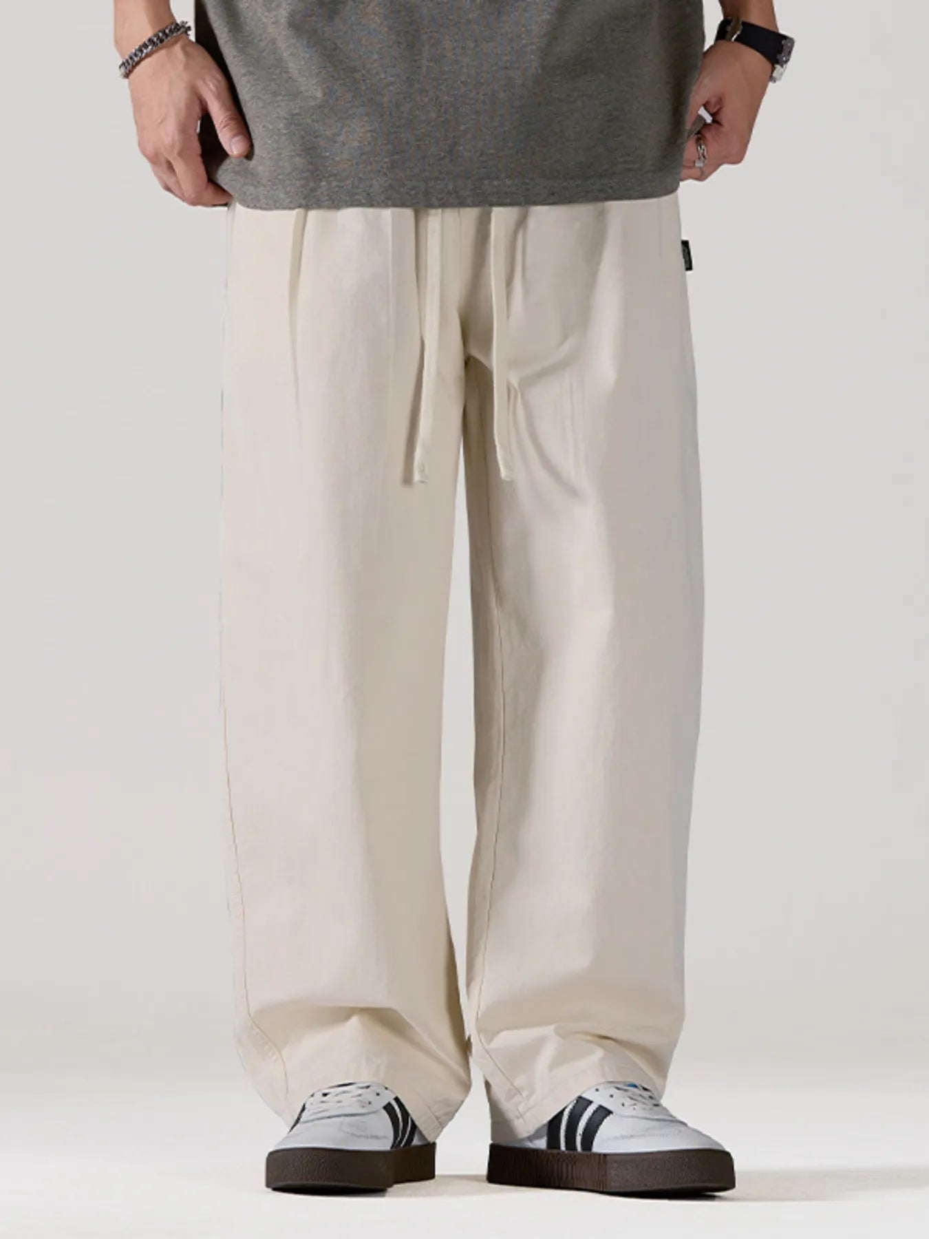 Men's light apricot oversized casual pants with a drawstring waist and pockets.