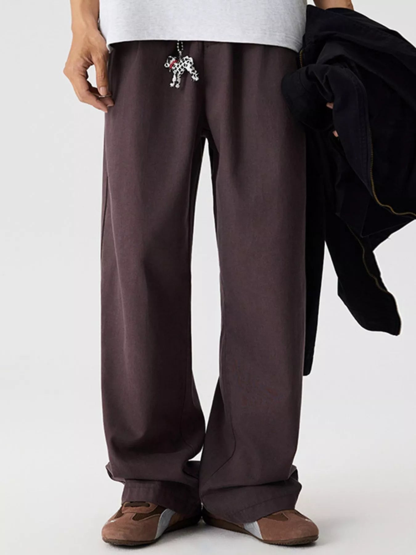 Men's relaxed fit pants with a drawstring waist and pockets.