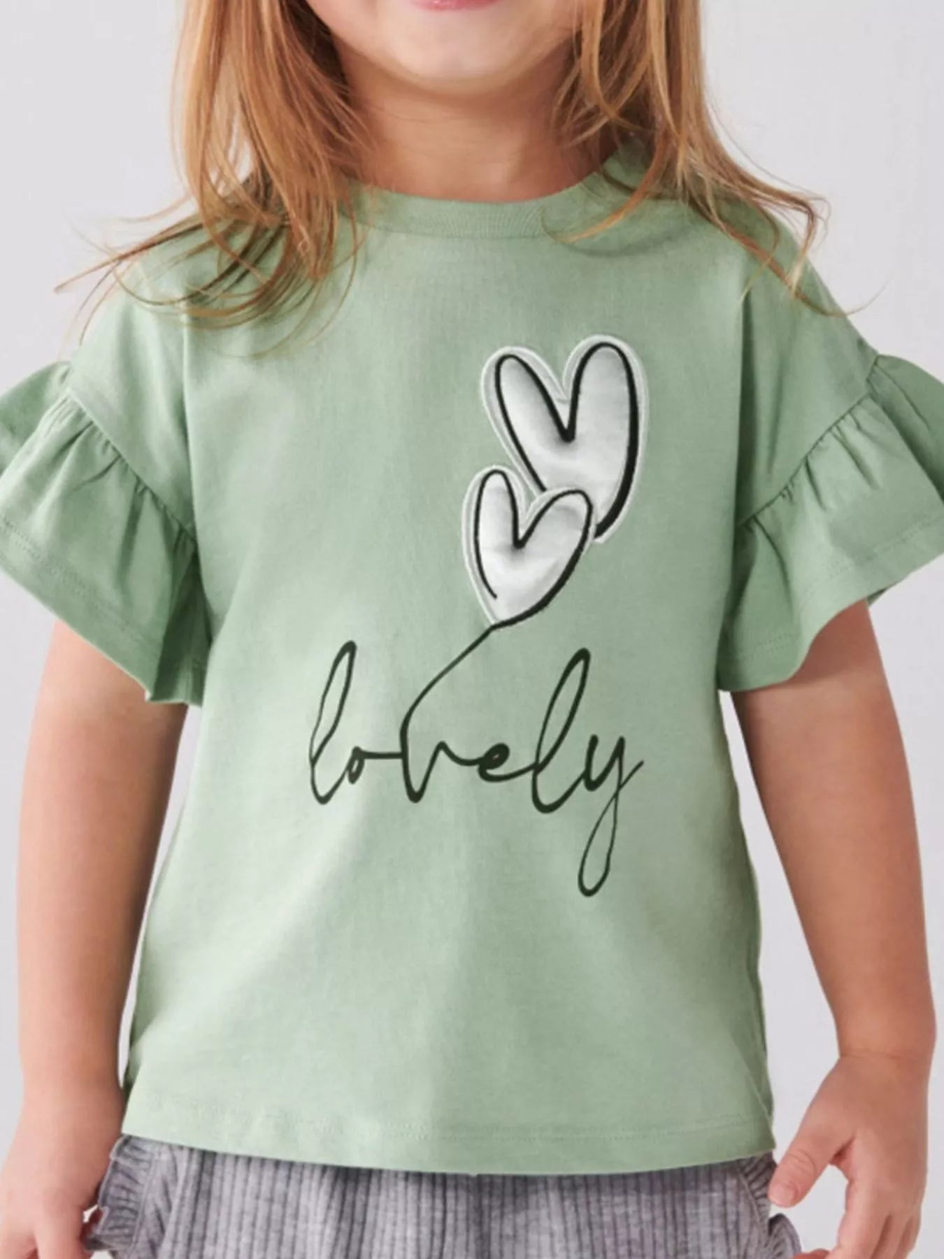 Sage green children's T-shirt with white heart appliques, lovely script and ruffle sleeves, front view