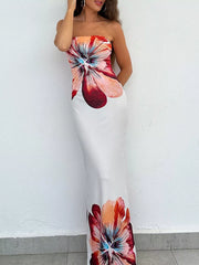 Front view of strapless bodycon maxi dress with large floral print against a white wall