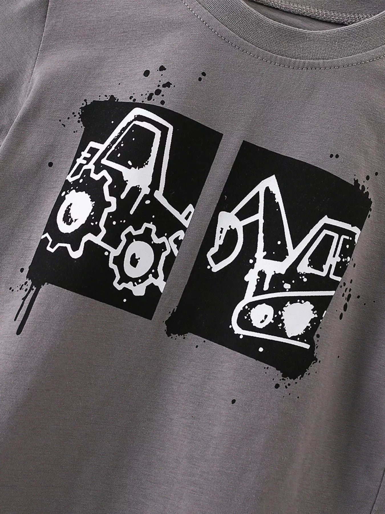 Close view of the black and white tractor and excavator graphic on dark gray fabric