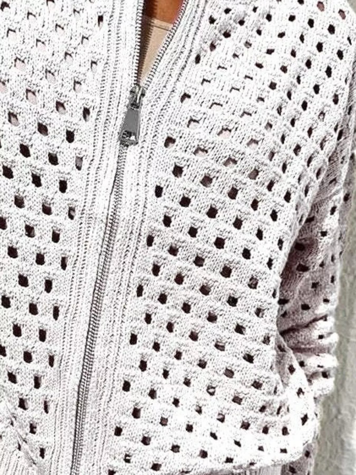 Close up of the white crochet cardigan zip and openwork knit texture