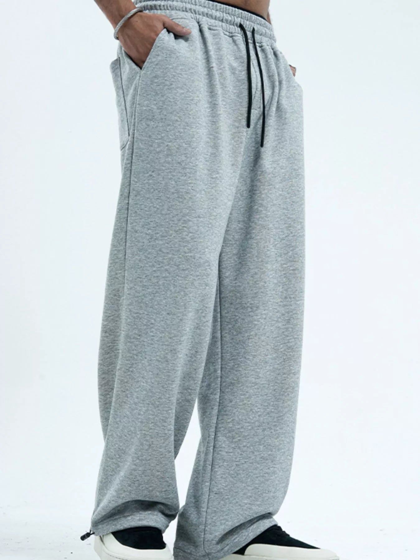 Men's gray wide-leg pants with a drawstring waist.