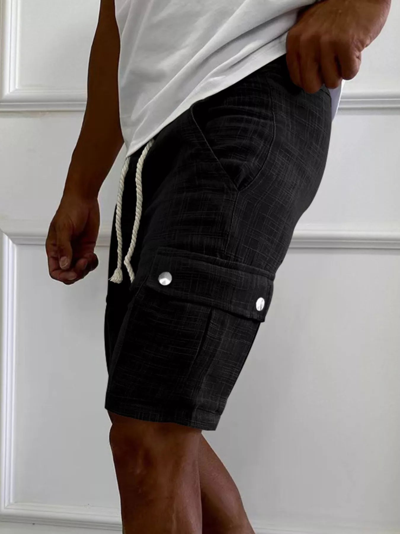 Men's black cargo shorts with a drawstring waist and pockets.