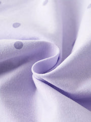 Close view of the soft lavender polka dot fabric of a children's t shirt