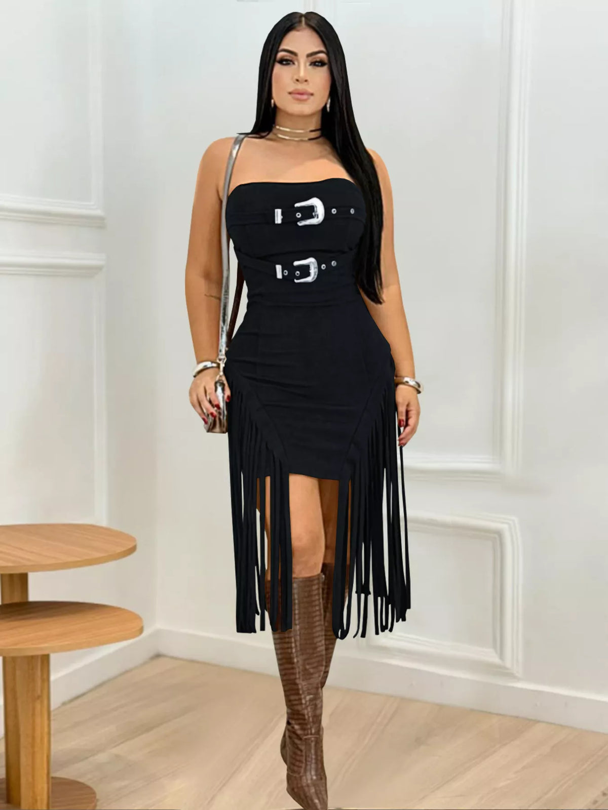 Black strapless bodycon dress with silver buckles and long fringe hem, front view on model