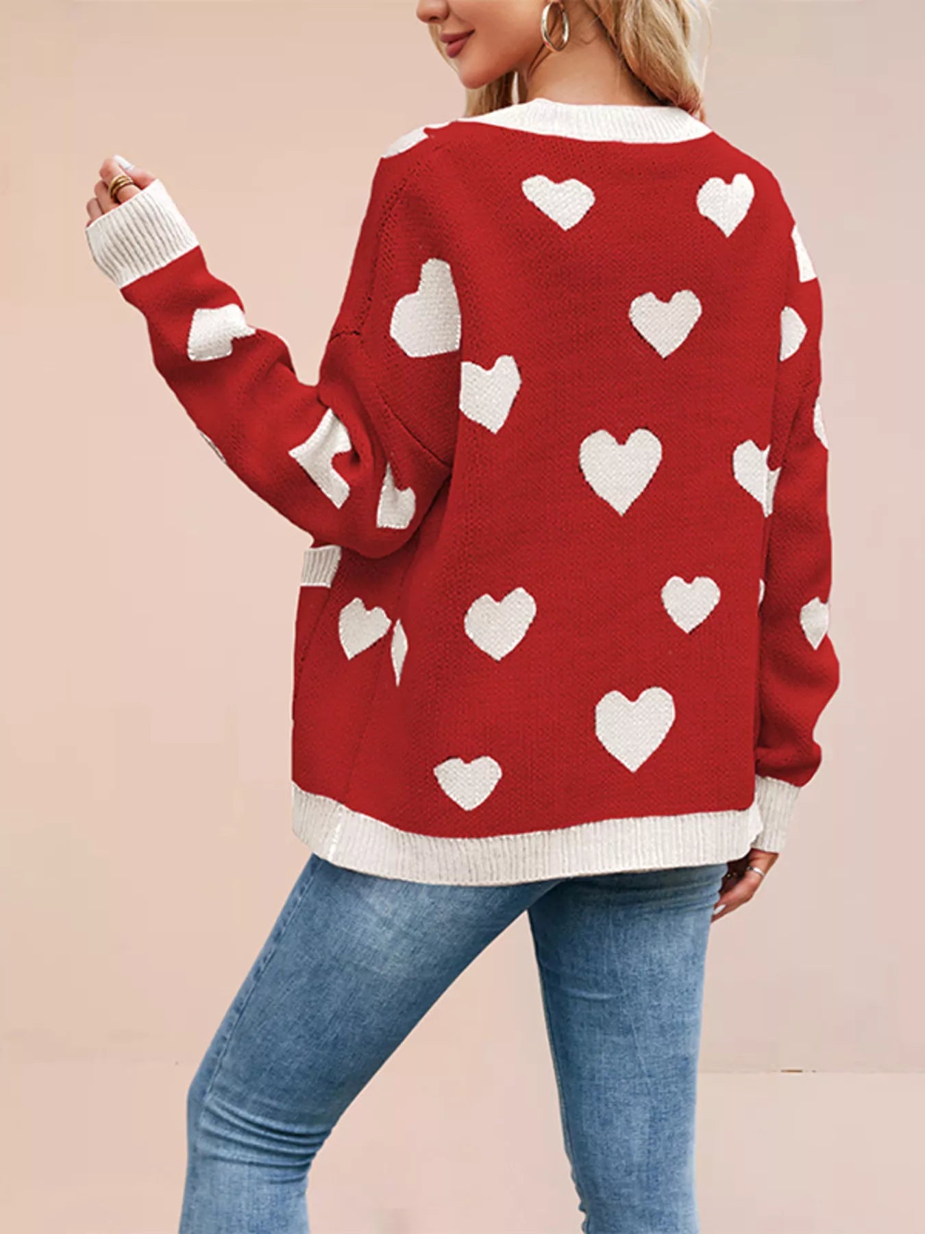 Back view of the red knit cardigan with white hearts and cream trim