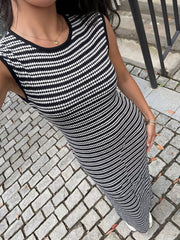 High angle view of a black and white striped sleeveless knit maxi dress showing the knit texture