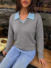 Seated front view of the gray knit sweater with a light blue polo collar
