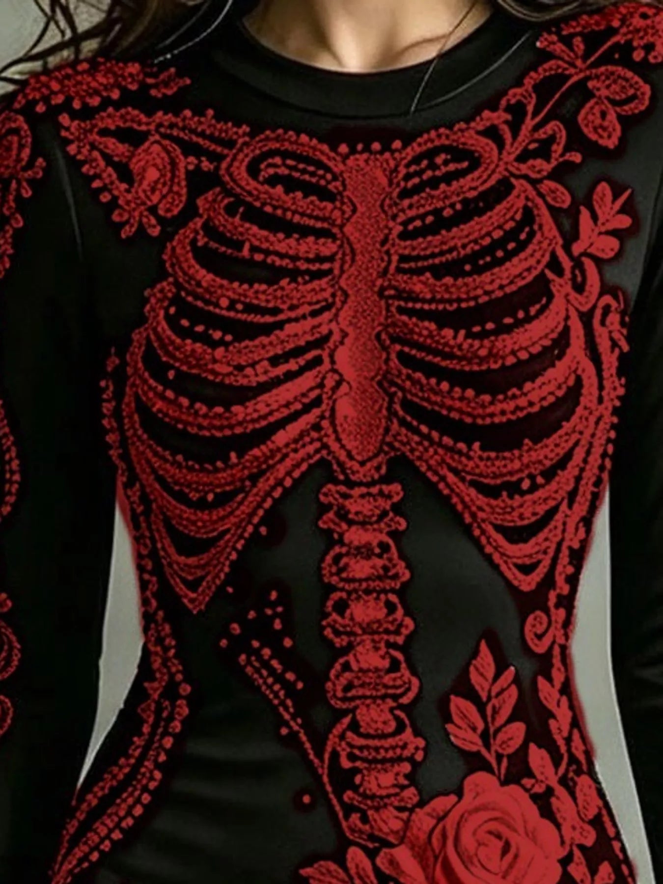 Close detail of dark red skeleton print on black long sleeve bodycon dress bodice