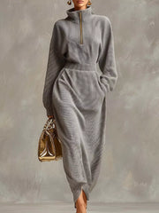 Front view of a grey waffle knit quarter zip midi dress with long sleeves and side slit