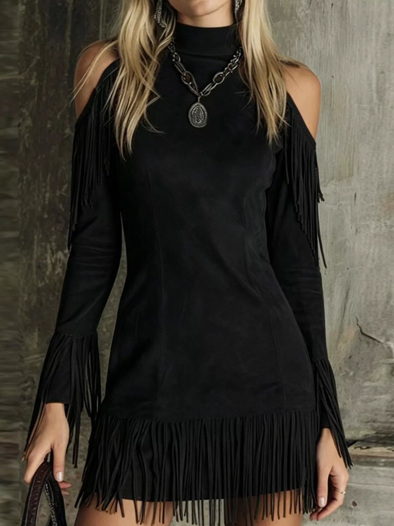 Black fringed cold shoulder mini dress worn front with long sleeves and fringe hem