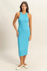 Model wearing bright blue sleeveless ribbed knit bodycon dress and white flats in full front view