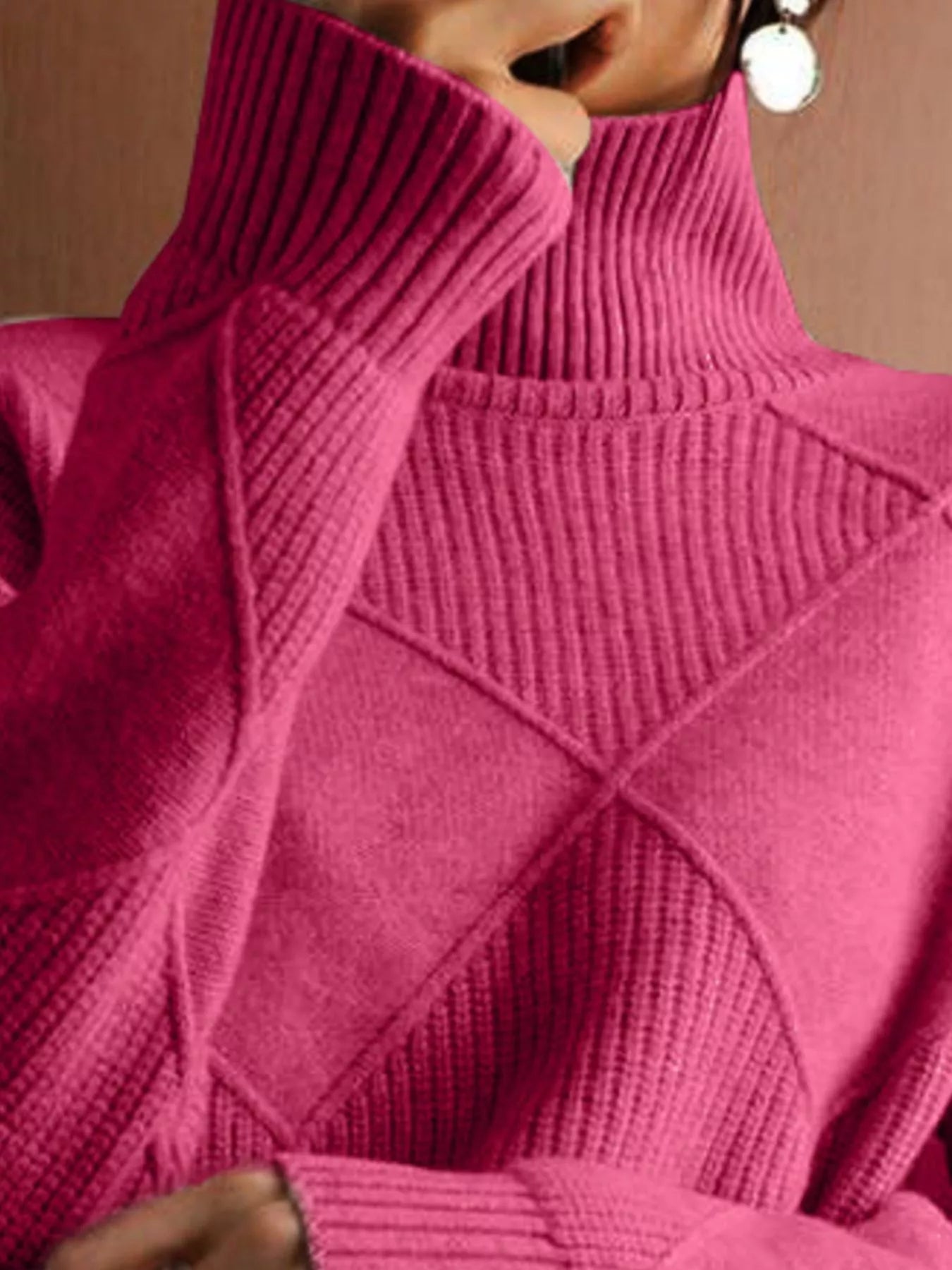 Close up of the cerise ribbed turtleneck and diamond patterned chest