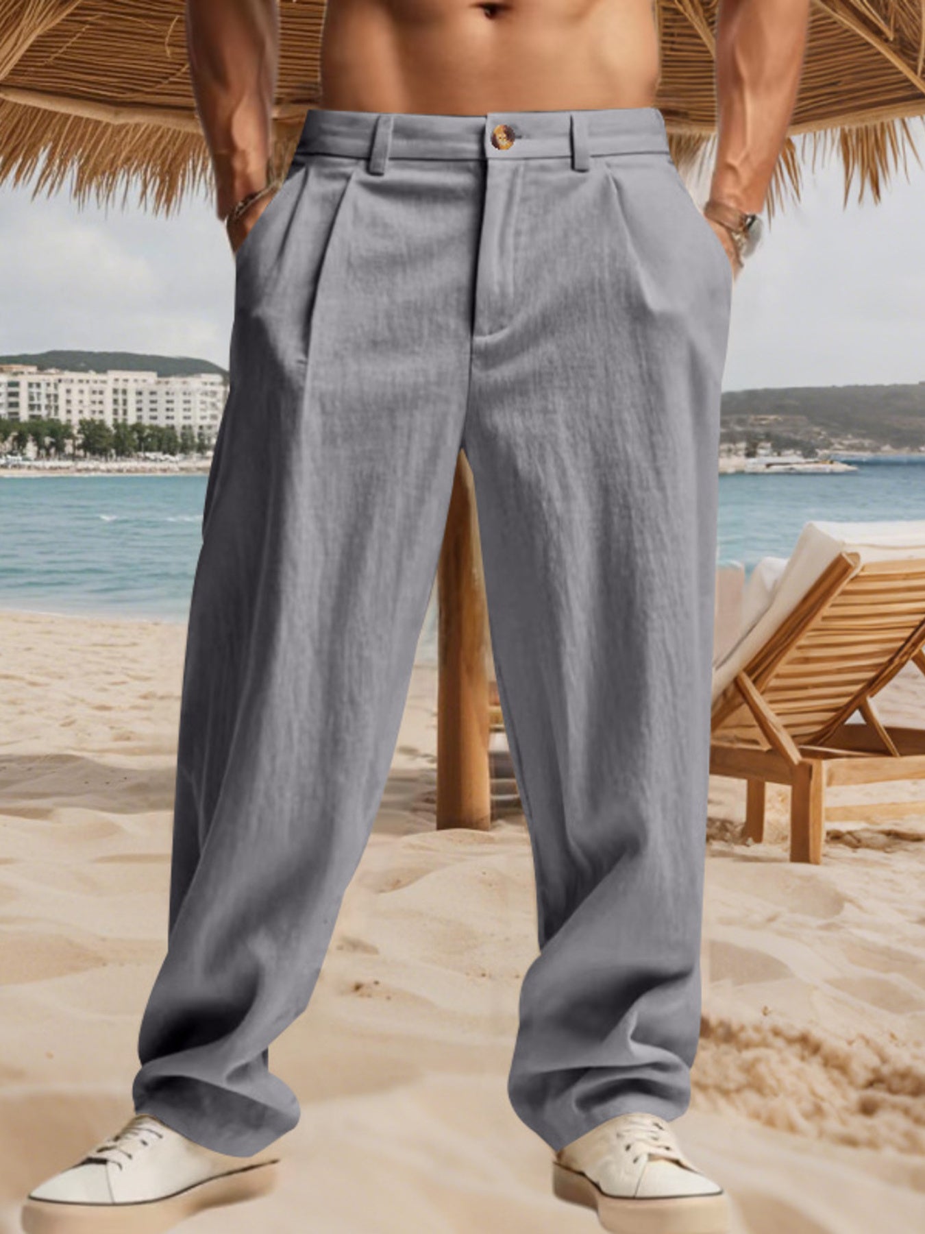Men's grey pleated pants with pockets and a relaxed fit.