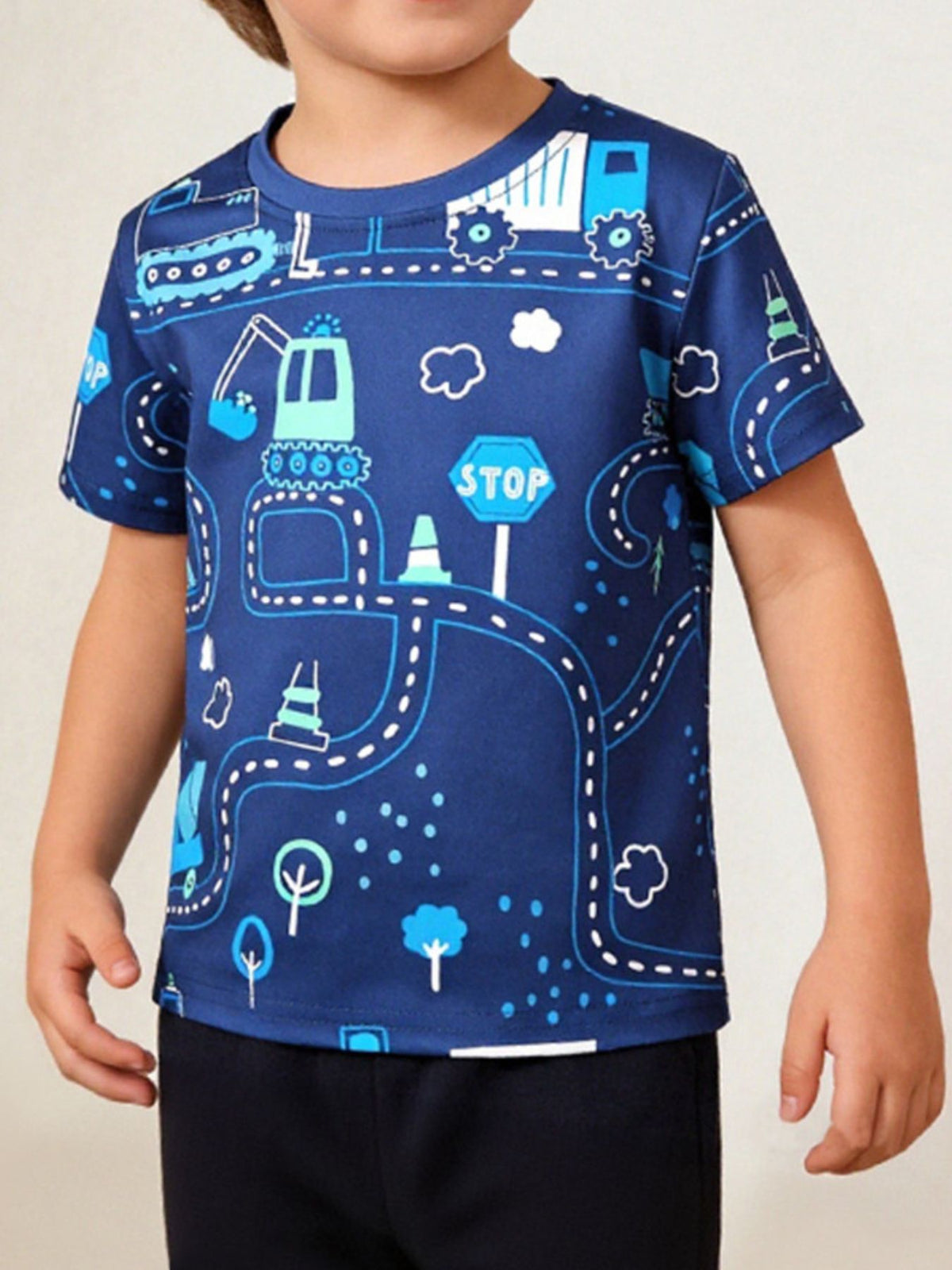 Children's dark blue tee worn in front view with road and construction vehicle print