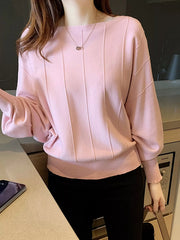Close front view of the blush pink batwing sleeve knit top with vertical seams and ribbed hem.