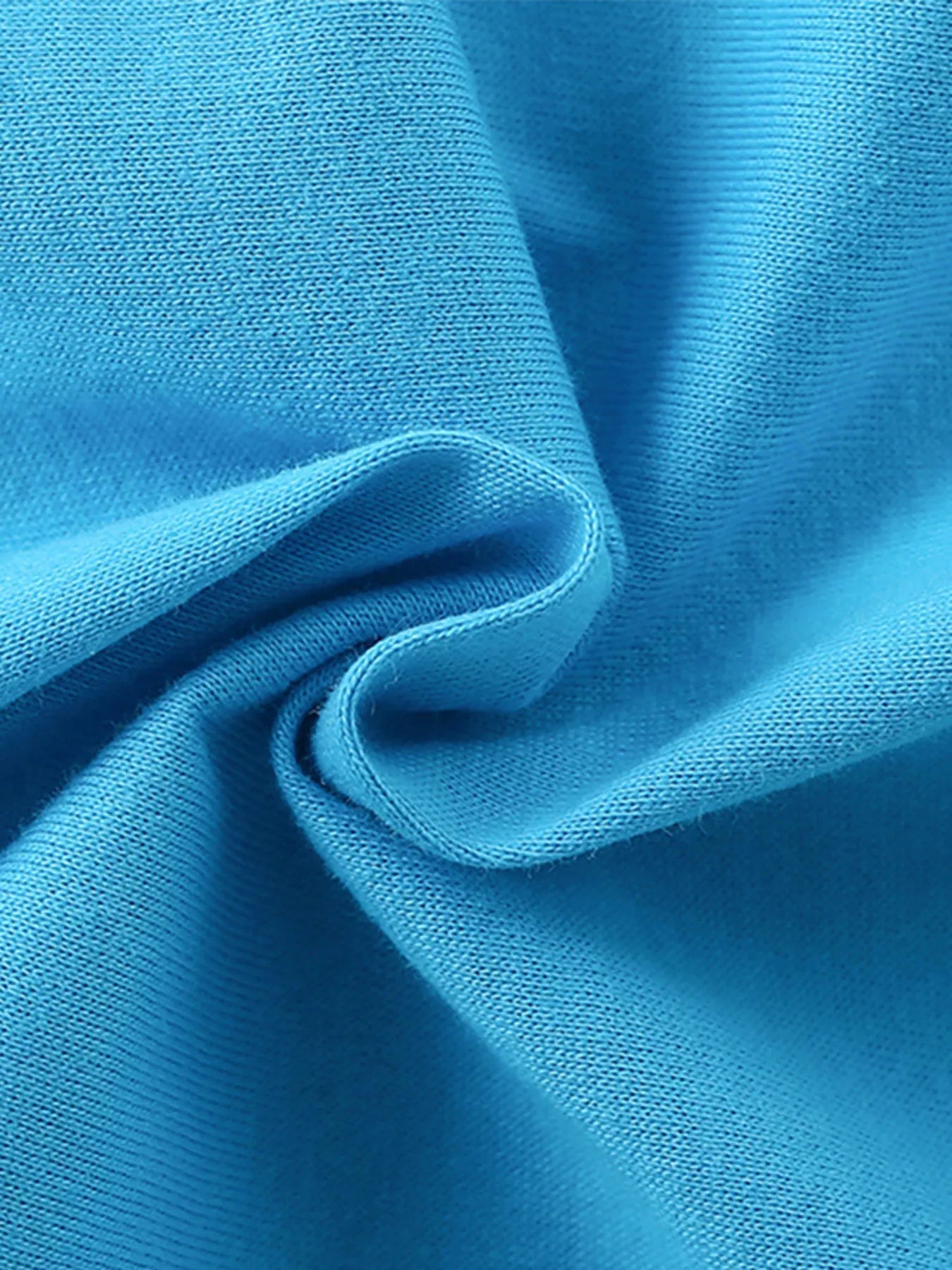 Close-up of soft sky blue cotton fabric texture with gentle folds