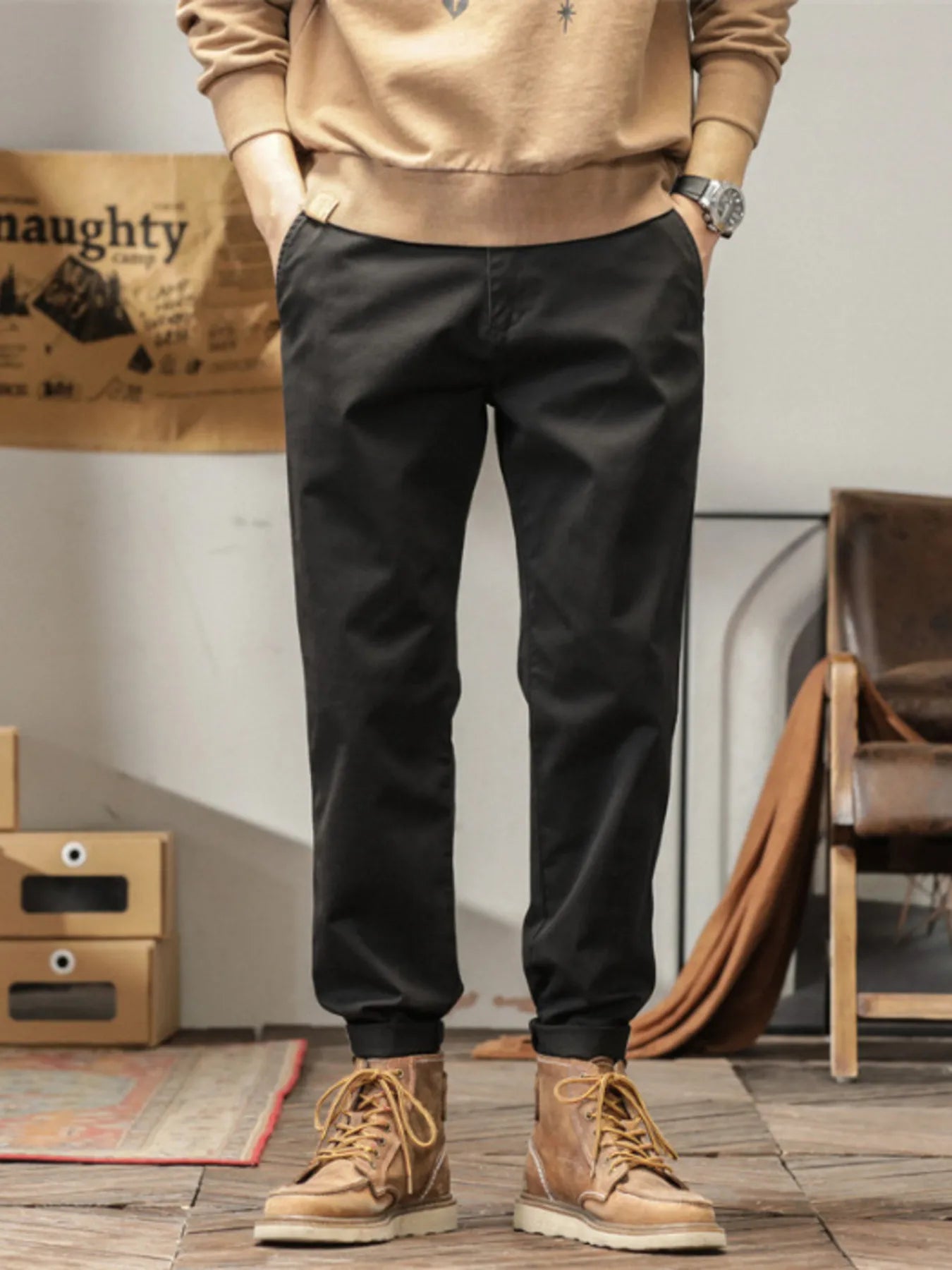 Men's slim fit casual pants with banded ankles and pockets.
