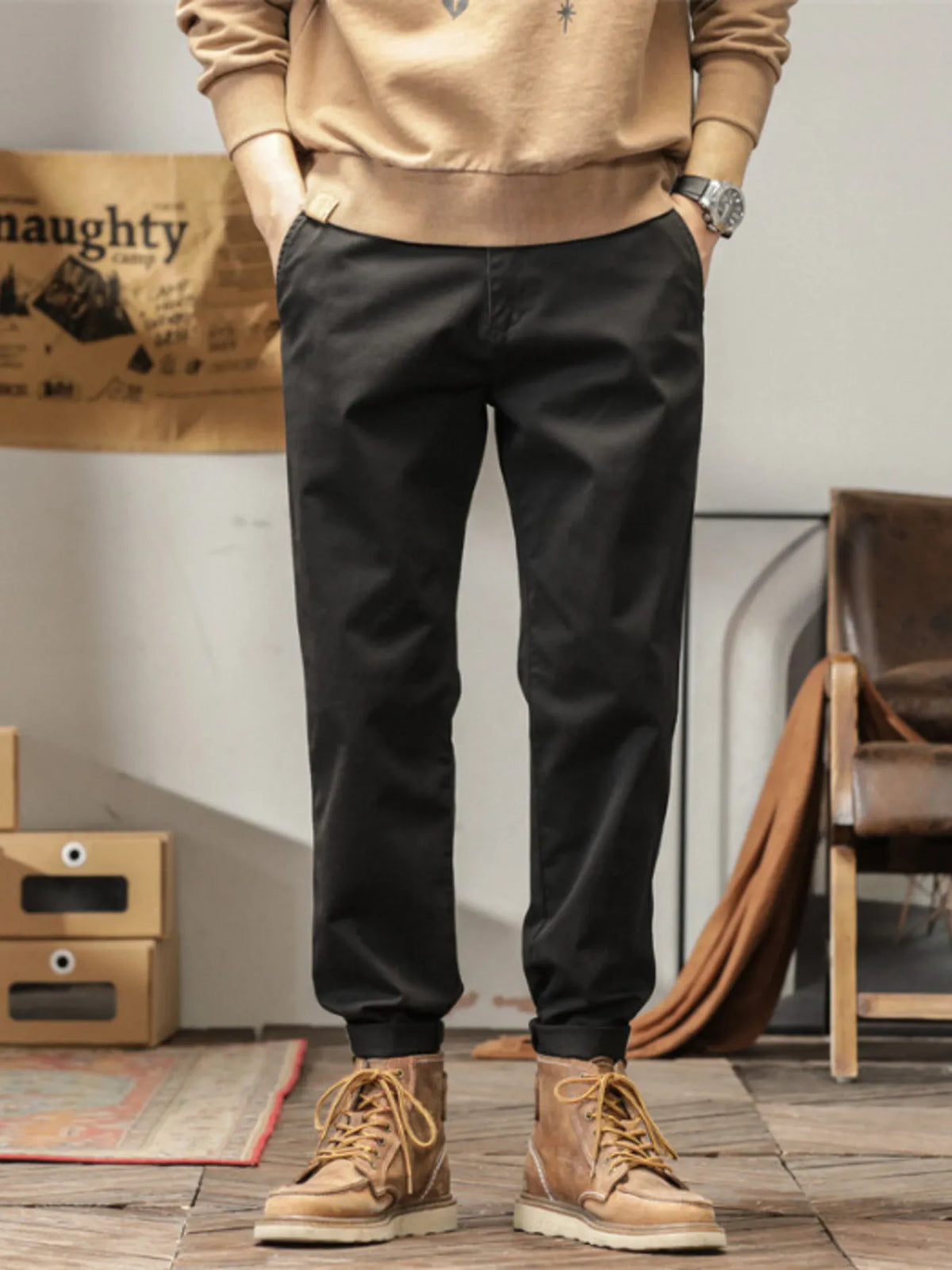 Men's slim fit casual pants with banded ankles and pockets.