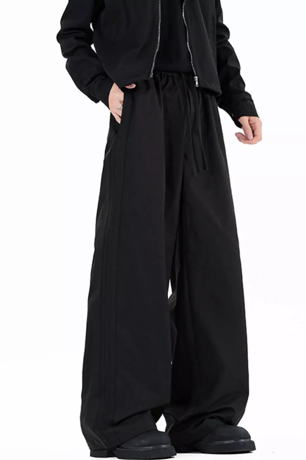 Men's wide leg casual pants with a drawstring waist and pockets.