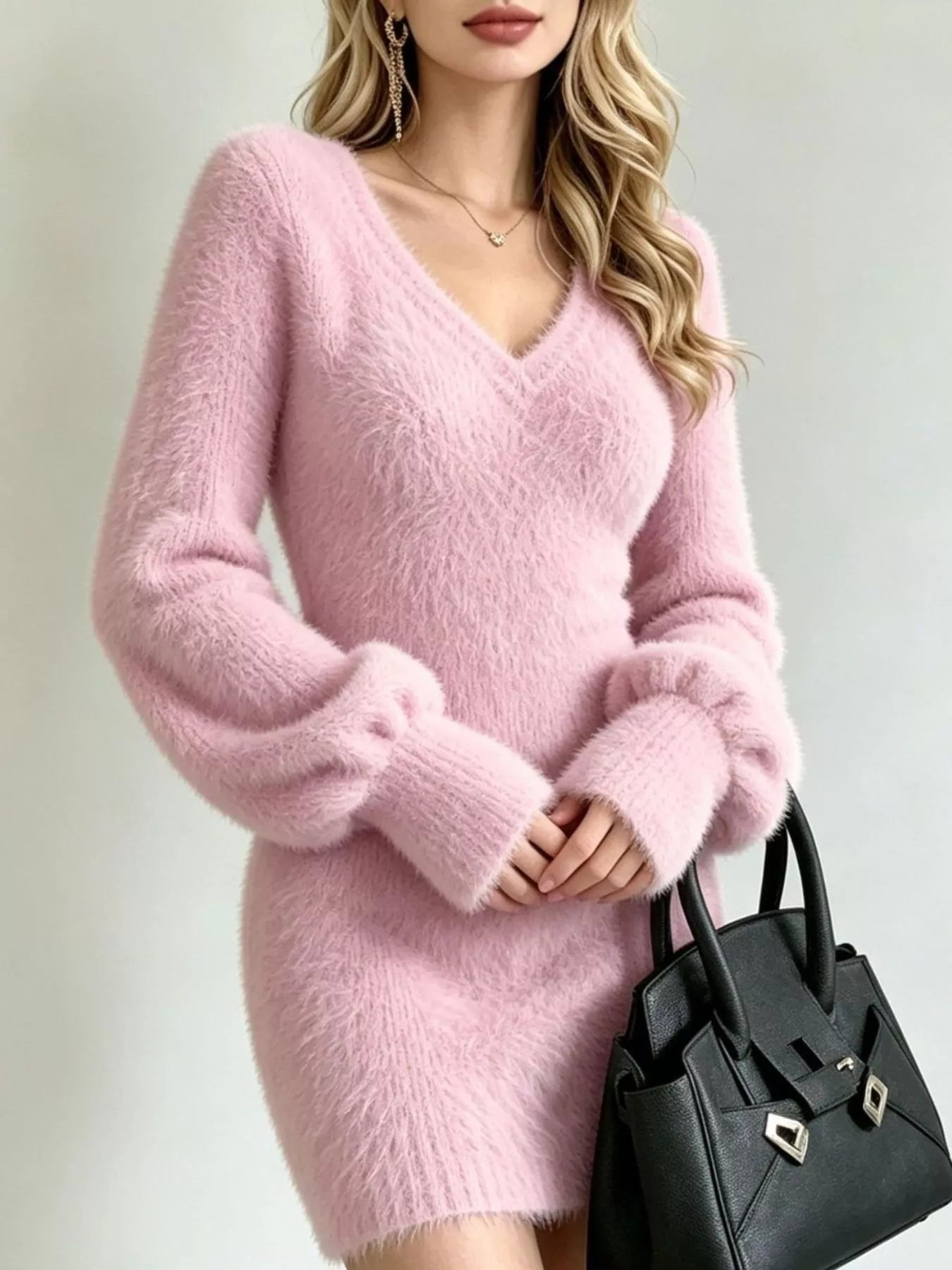 Pink fuzzy knit sweater dress, close front view of V neckline and puff sleeves