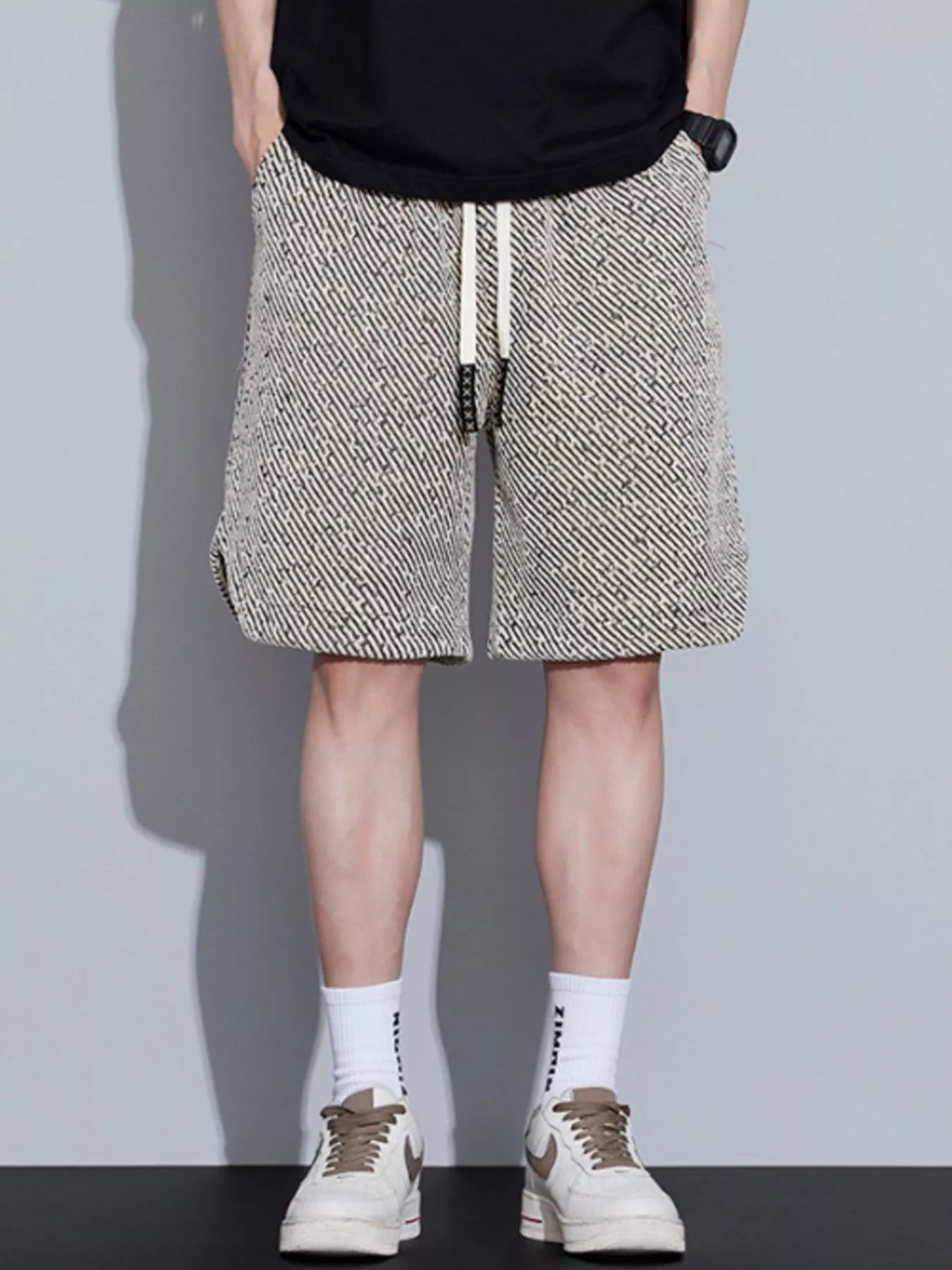 Men's loose fit shorts with a drawstring waist and pockets.