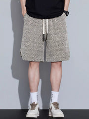 Men's loose fit shorts with a drawstring waist and pockets.