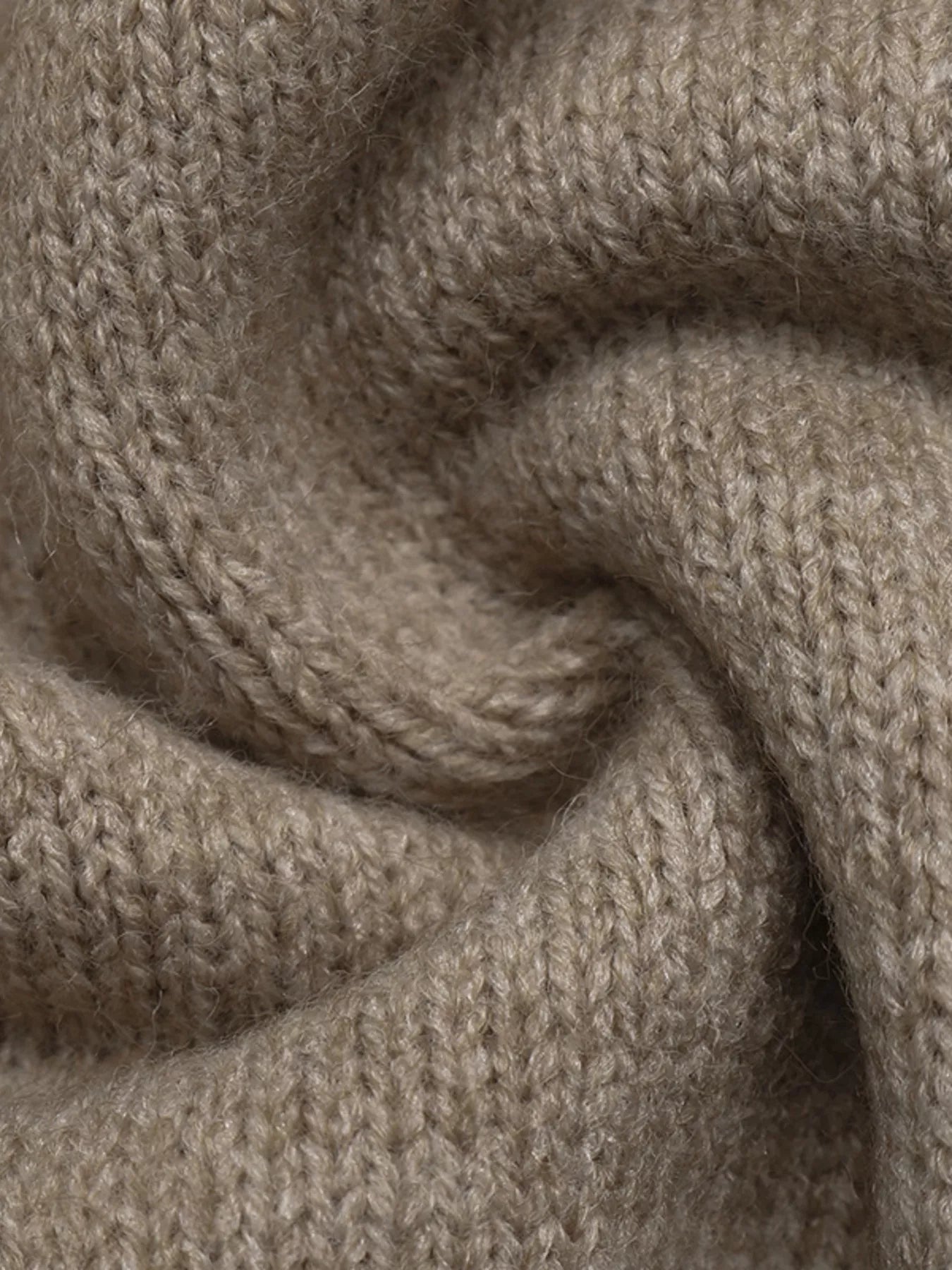 Extreme close up of khaki knit fabric showing soft textured weave
