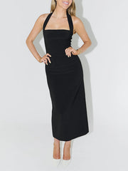 Studio front view of black halter neck bodycon midi dress with hands on hips