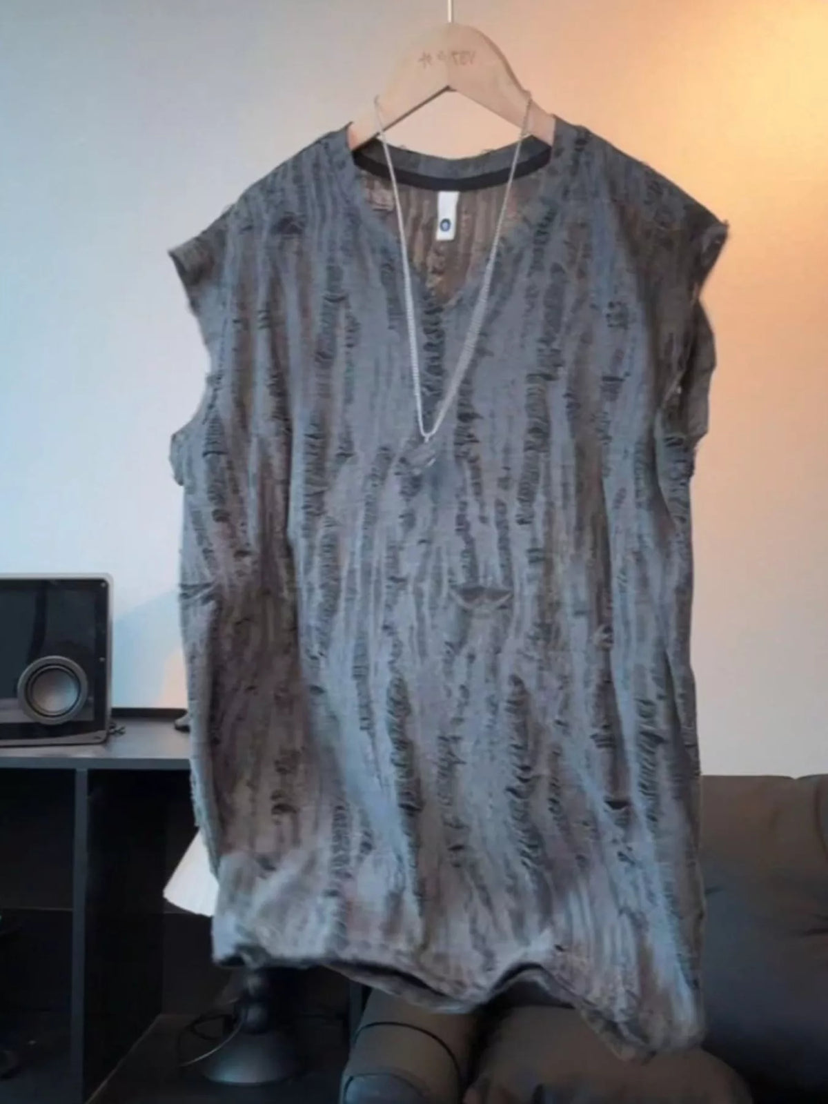 Men's lightweight distressed top with a round neckline and slight stretch.