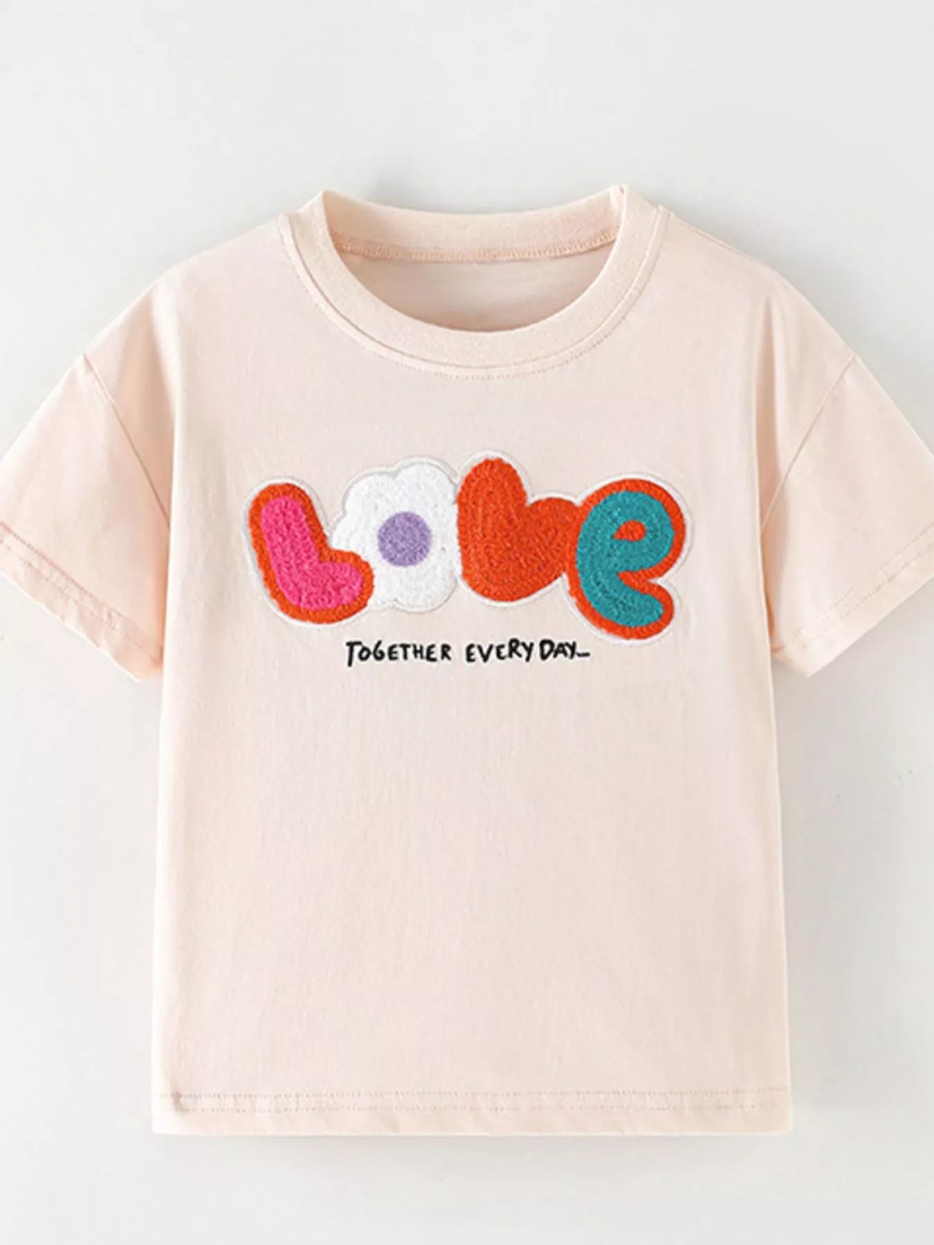 Front view of the watermelon pink children's t-shirt with colorful LOVE applique and small together every day text