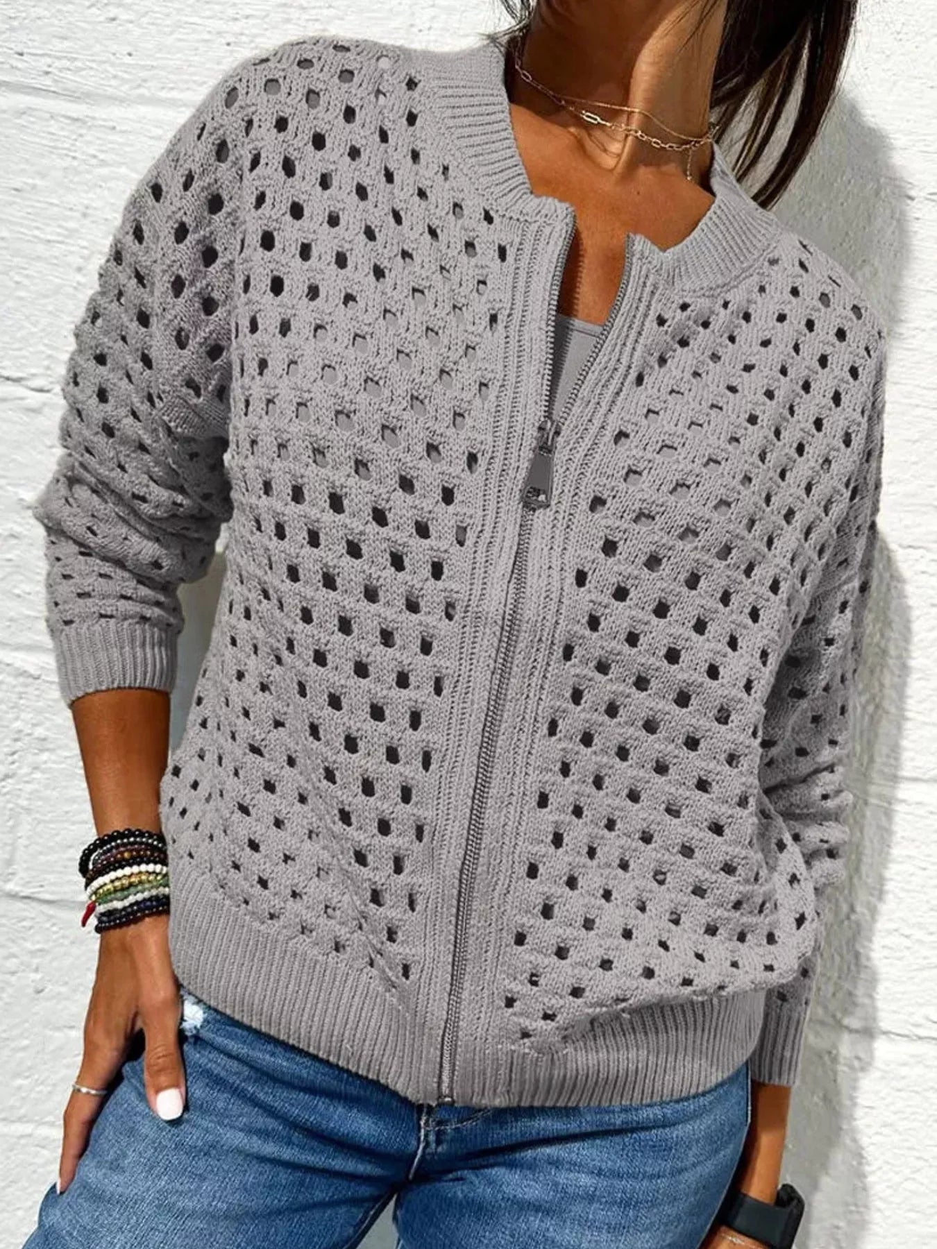 Front view of a light gray openwork crochet cardigan with a front zip