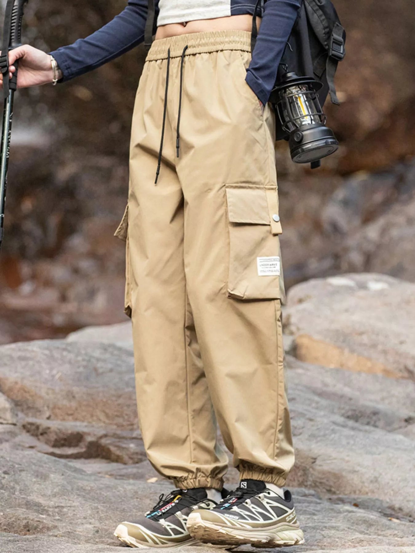 Men's khaki loose-fit cargo pants with a drawstring waist and pockets.