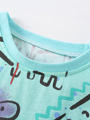 Close-up of mint crew neckline and stitching on multicolor children's dinosaur print t-shirt