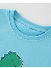 Close-up of ribbed crew neckline and top of green dinosaur graphic on sky blue tee