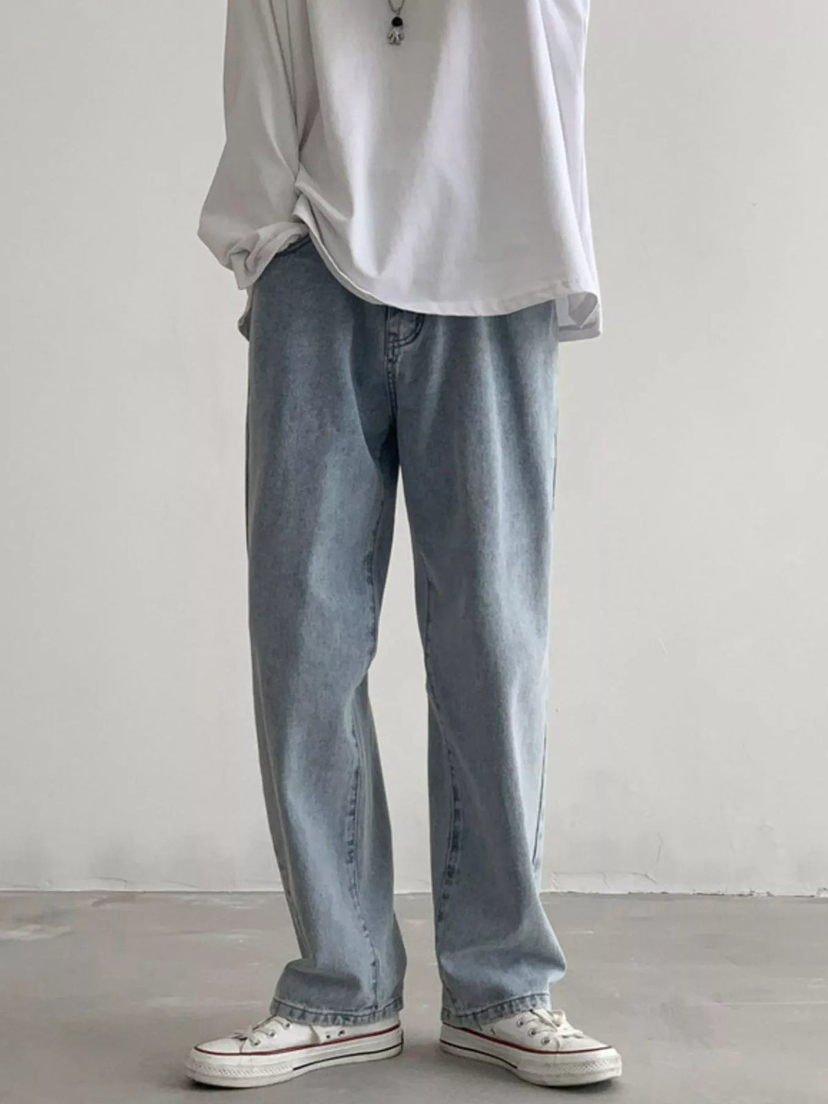 Men's Air Force Blue loose fit wash jeans on model, front view with white sneakers.