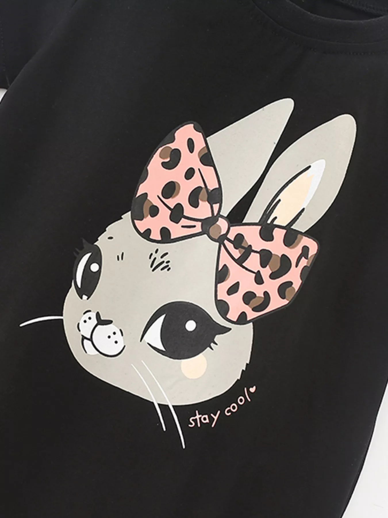 Close view of the gray bunny face graphic with pink leopard bow and small stay cool lettering