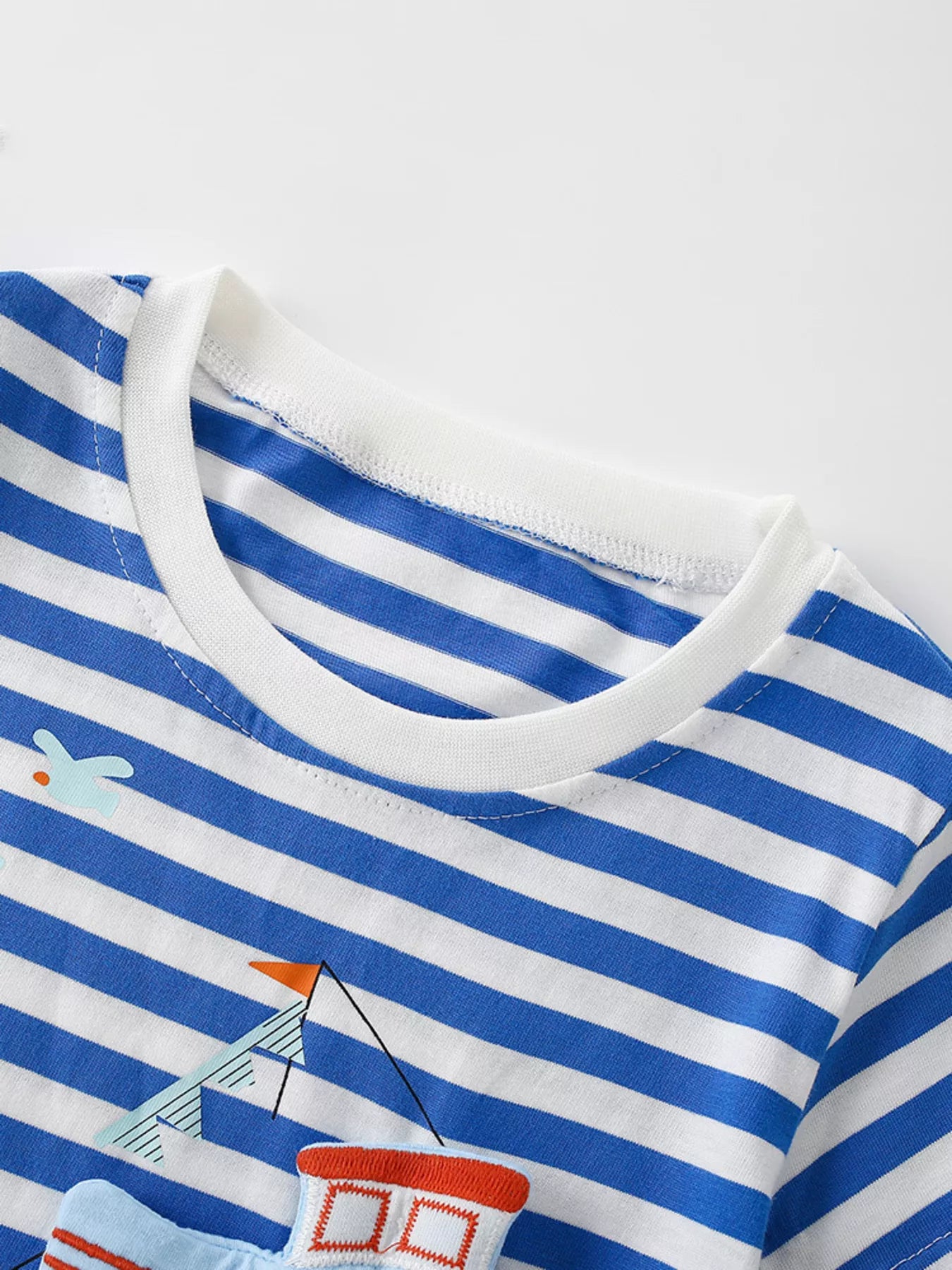 Close up of the white round neckline on a children's blue and white striped short sleeve tee