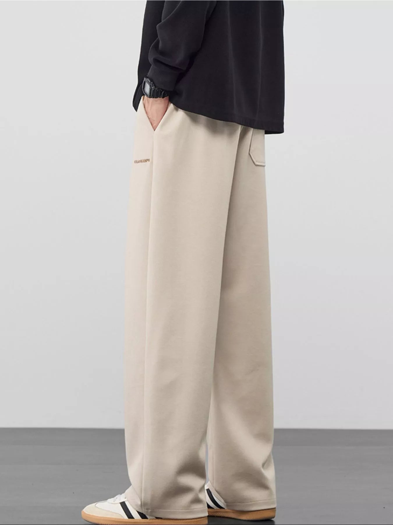 Men's loose fit casual pants with a drawstring waist and pockets.