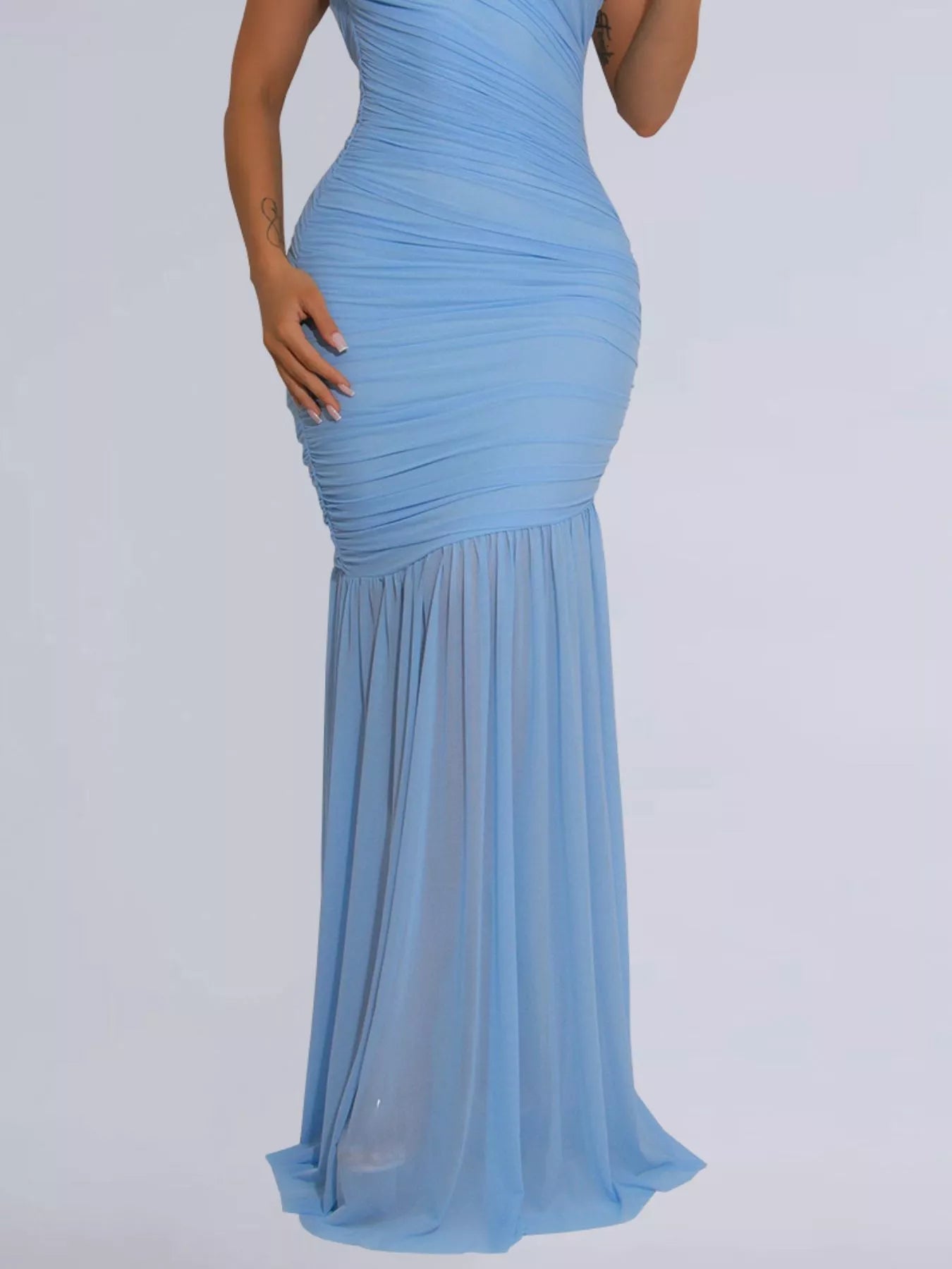 Lower view of light blue ruched bodycon maxi dress showing the flowing skirt