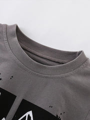 Close view of the ribbed crew neck on a dark gray children's t shirt
