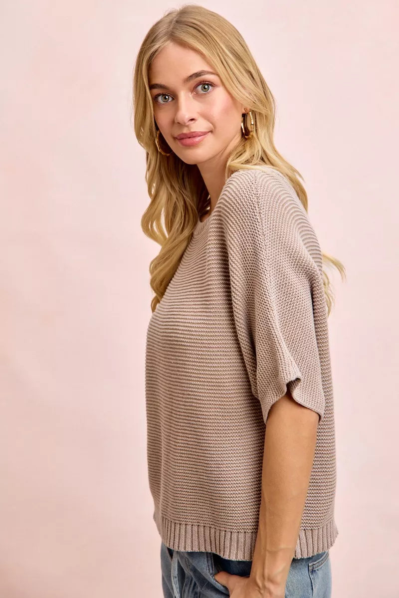 Side view of washed mocha knit top with short dolman sleeves and ribbed hem.