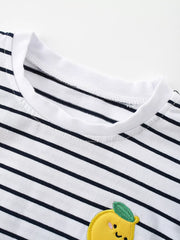Close-up of the white round neckline and navy stripes with the top of the lemon applique visible