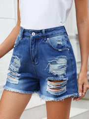 Women's distressed denim shorts with raw hems and slightly stretchy fabric.