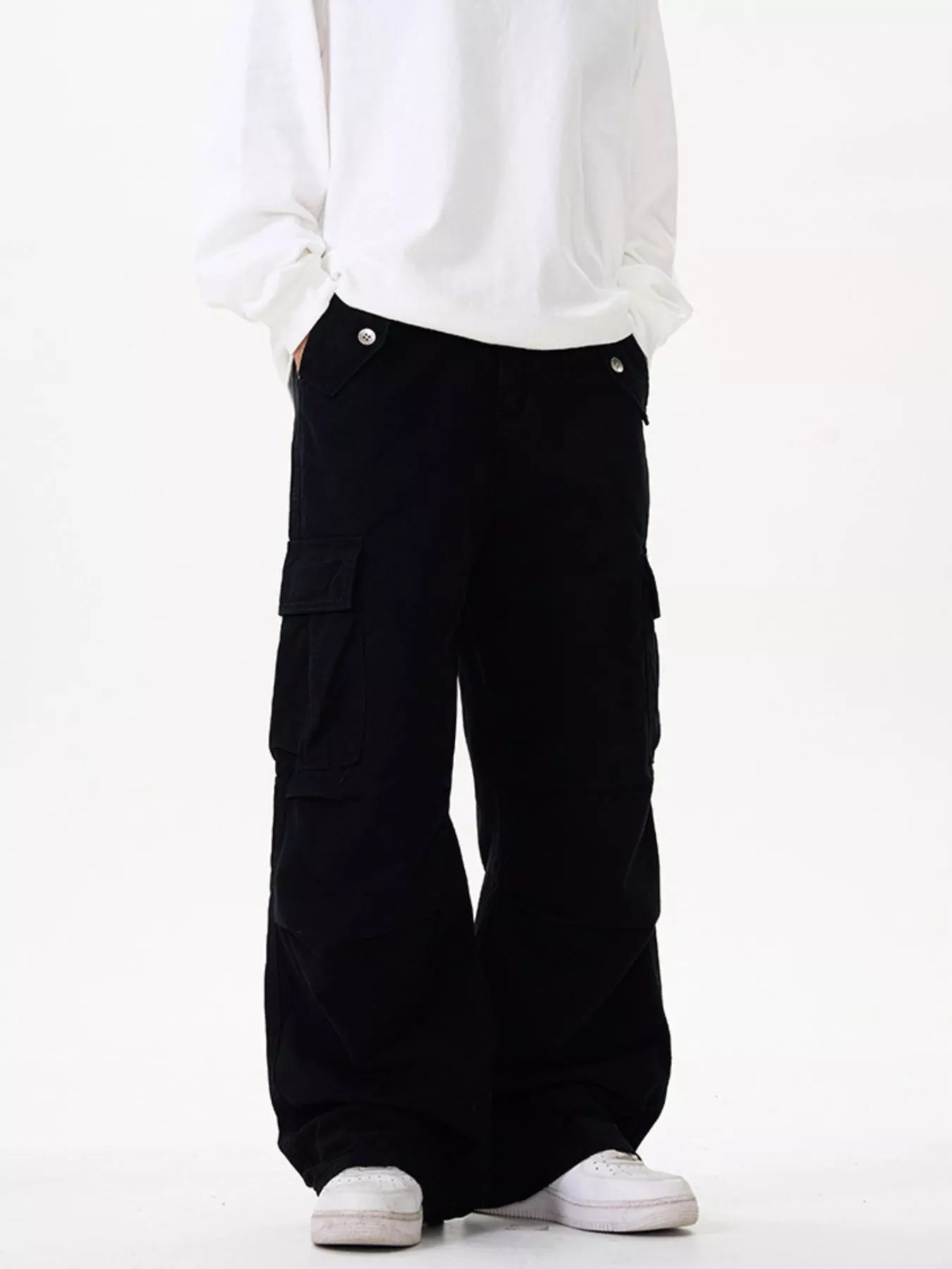 Men's black cotton cargo pants with a loose fit and pockets.