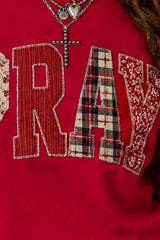Close detail of scarlet western sweatshirt showing striped, plaid and patterned patch letters