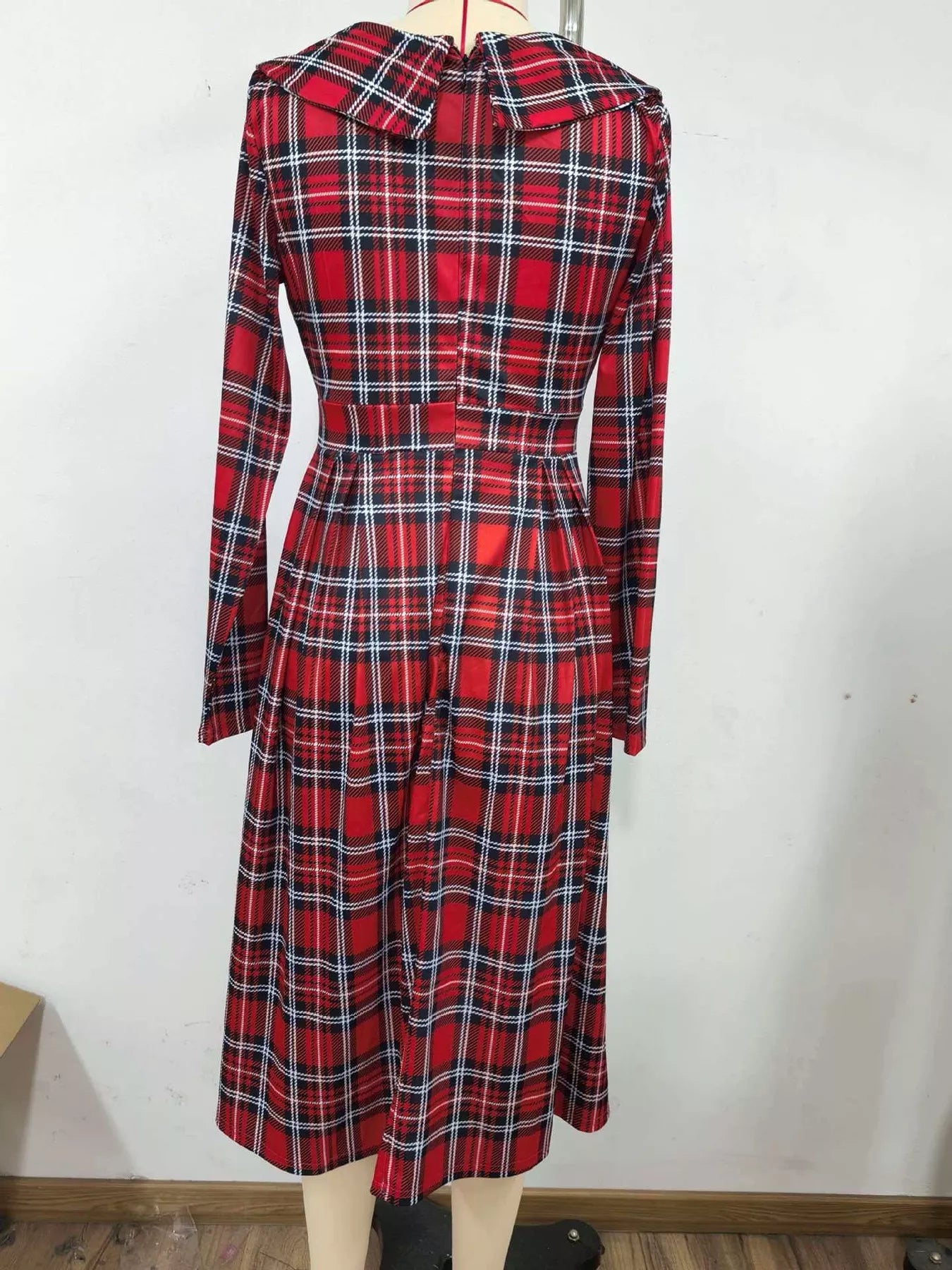 Burgundy plaid long sleeve midi dress on a mannequin, back view with wide collar and fitted waist